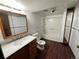 Updated bathroom features a bathtub, toilet and vanity with a large mirror at 8055 E Bethany Pl, Denver, CO 80231