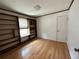 Bright bedroom with built-in bookshelves and hardwood floors at 8055 E Bethany Pl, Denver, CO 80231