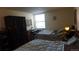 Bedroom with a large bed, dark wardrobe, and a desk at 13901 E Marina Dr # 308, Aurora, CO 80014