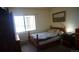 Cozy bedroom with a wooden bed and window at 13901 E Marina Dr # 308, Aurora, CO 80014
