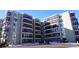 Exterior view of a light-green multi-story building with snow on the ground at 13901 E Marina Dr # 308, Aurora, CO 80014