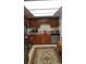 Kitchen with wood cabinets, stainless steel appliances, and patterned rug at 13901 E Marina Dr # 308, Aurora, CO 80014
