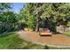 Landscaped backyard with seating area under tree at 6780 S Grant St, Centennial, CO 80122