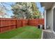 Private backyard with artificial turf and wood fence at 7476 E Arkansas Ave # 40-08, Denver, CO 80231