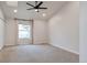 Bright bedroom featuring a large window and ceiling fan at 7476 E Arkansas Ave # 40-08, Denver, CO 80231