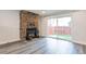 Living room with stone fireplace and sliding glass doors to backyard at 7476 E Arkansas Ave # 40-08, Denver, CO 80231