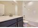 Modern bathroom with subway tile, a soaking tub, and a double vanity at 8363 Mount Kataka St, Littleton, CO 80125