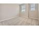 Bright bedroom with neutral walls and carpet, featuring two large windows with blinds at 8363 Mount Kataka St, Littleton, CO 80125