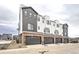 Modern three-story townhome with attached garage and neutral colors at 8363 Mount Kataka St, Littleton, CO 80125