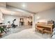 Finished basement recreation area with exercise equipment and piano at 7339 Shoreham Pl, Castle Pines, CO 80108