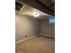 Unfinished basement with neutral walls and carpeted floor at 1860 S Dahlia St, Denver, CO 80222