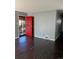 Home entryway with red door and dark floors at 1860 S Dahlia St, Denver, CO 80222