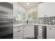 Corner kitchen with white cabinets and stainless steel appliances at 1543 Feltham Pl, Longmont, CO 80501