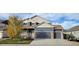 Two-story house with gray siding, a two-car garage, and landscaping in the front yard at 9023 Harlequin Cir, Longmont, CO 80504