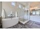 Spa-like bathroom with soaking tub, walk-in shower and marble finishes at 4673 W 50Th Pl, Denver, CO 80212