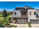 Modern home with brick and siding exterior, attached garage, and landscaping at 4673 W 50Th Pl, Denver, CO 80212
