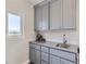 Wet bar with gray cabinets, sink, and plenty of storage at 4673 W 50Th Pl, Denver, CO 80212