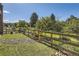 Landscaped backyard with wooden fence and mature trees at 4673 W 50Th Pl, Denver, CO 80212