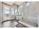 Bathroom with a freestanding tub, walk-in shower, and access to private deck at 4673 W 50Th Pl, Denver, CO 80212