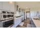 Modern kitchen with stainless steel appliances and white cabinetry at 4673 W 50Th Pl, Denver, CO 80212