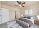 Bright bedroom with ceiling fan and view of bathroom at 1801 S Dunkirk St # 303, Aurora, CO 80017
