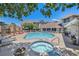 Relaxing pool and hot tub area with lounge chairs and brick accents at 1801 S Dunkirk St # 303, Aurora, CO 80017