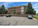 Exterior view of a brick building with parking spaces in front at 13950 E Oxford Pl # A104, Aurora, CO 80014