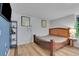 Spacious bedroom with wood flooring and a large wooden bed frame at 13950 E Oxford Pl # A104, Aurora, CO 80014