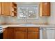 Kitchen features a double sink and wood cabinets at 2951 S Walden Ct, Aurora, CO 80013