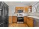 Modern kitchen with stainless steel appliances and wood cabinets at 2951 S Walden Ct, Aurora, CO 80013