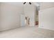 Spacious carpeted bedroom with views into adjacent bathroom and kitchen at 2951 S Walden Ct, Aurora, CO 80013