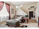 Living room with couch, ottoman, and window at 14389 E 101St Pl, Commerce City, CO 80022
