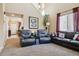 Comfortable living room with two armchairs and a sofa at 14389 E 101St Pl, Commerce City, CO 80022