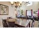 Well-lit dining room with dark wood table and chairs at 14389 E 101St Pl, Commerce City, CO 80022