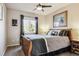 Bright bedroom with a comfortable bed, ceiling fan, and large window at 14389 E 101St Pl, Commerce City, CO 80022