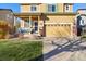 Two-story home with front porch and attached garage at 14389 E 101St Pl, Commerce City, CO 80022