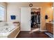 Bathroom with soaking tub, walk-in closet, and double vanity at 14389 E 101St Pl, Commerce City, CO 80022