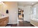 Main bathroom with double vanity, soaking tub, and a separate shower at 14389 E 101St Pl, Commerce City, CO 80022