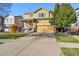 Two-story home with front porch and attached garage at 14389 E 101St Pl, Commerce City, CO 80022