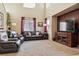 Relaxing living room featuring leather sofas and high ceilings at 14389 E 101St Pl, Commerce City, CO 80022