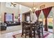 Spacious dining room with a chandelier and view of living room at 14389 E 101St Pl, Commerce City, CO 80022