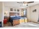 Spacious main bedroom with a king-size bed and ceiling fan at 14389 E 101St Pl, Commerce City, CO 80022