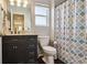 Bathroom features a vanity with dark cabinets and a shower/tub combo at 14389 E 101St Pl, Commerce City, CO 80022