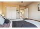 Bedroom with a queen bed, closet, and view of another room at 14389 E 101St Pl, Commerce City, CO 80022
