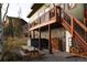 Deck with hot tub, woodpile, and picnic table at 1528 Chinook Rd, Idaho Springs, CO 80452