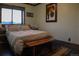 Bright bedroom with a wooden bench at the foot of the bed at 1528 Chinook Rd, Idaho Springs, CO 80452