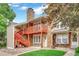 Brick townhouse with a wooden staircase and balcony, offering curb appeal at 1148 S Ventura Cir # E, Aurora, CO 80017