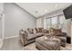 Open living area with L-shaped sofa and large window at 1148 S Ventura Cir # E, Aurora, CO 80017