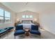 Bright bedroom with a king-size bed and two armchairs at 305 W Charles St, Superior, CO 80027