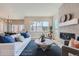 Open living room with fireplace, large windows, and a view of the kitchen at 305 W Charles St, Superior, CO 80027